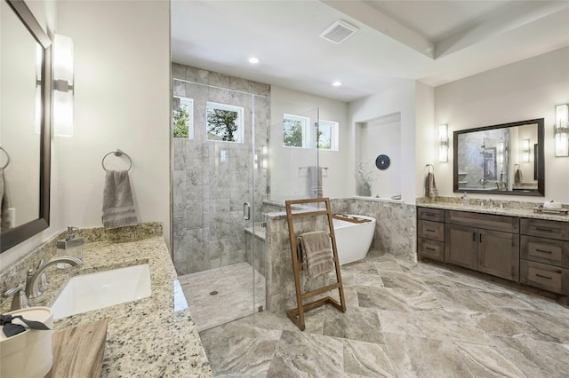 bathroom with vanity and separate shower and tub