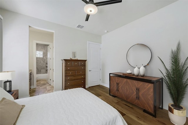 bedroom with dark hardwood / wood-style flooring, connected bathroom, and ceiling fan