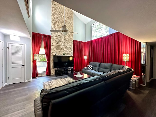 living room with hardwood / wood-style flooring, ceiling fan, and high vaulted ceiling