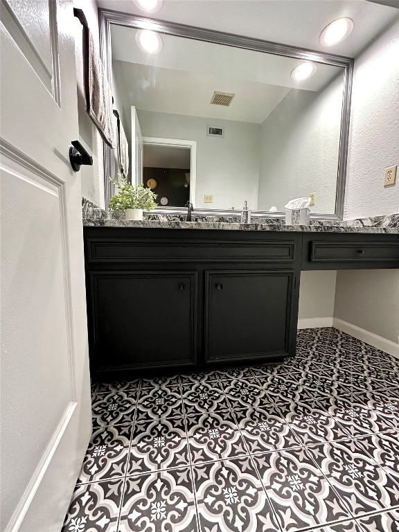 bathroom with tile patterned flooring and vanity