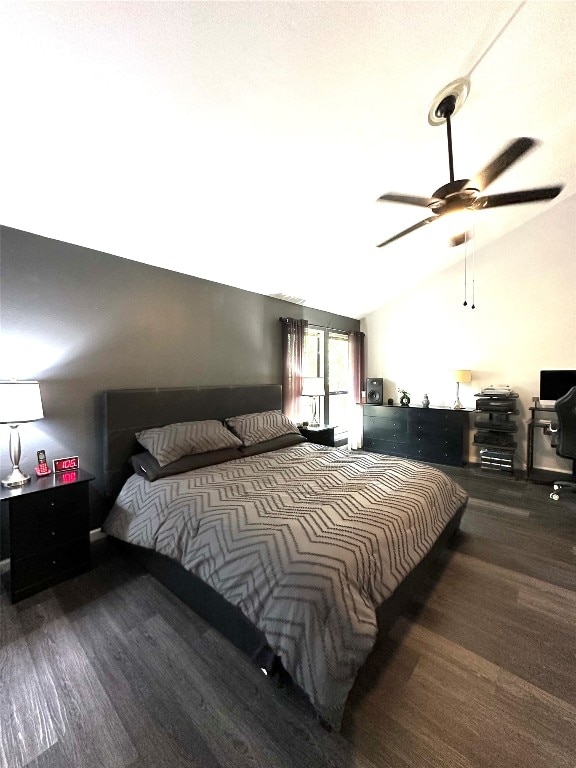 bedroom featuring vaulted ceiling, dark hardwood / wood-style flooring, and ceiling fan