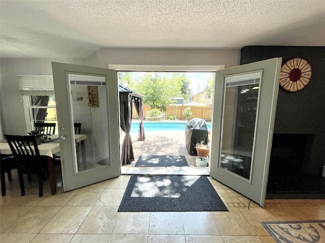 entryway featuring french doors and a textured ceiling