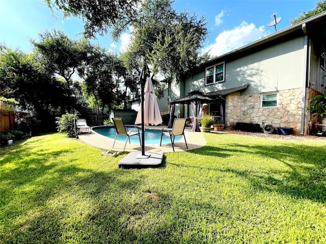 view of yard with a fenced in pool and a gazebo