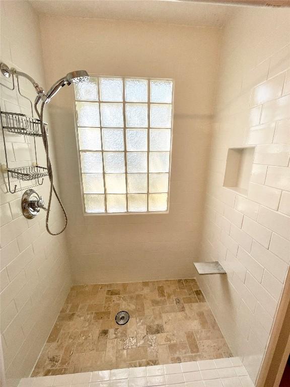 13242 Kerrville Folkway, Austin, TX 78729 - bathroom featuring tiled shower
