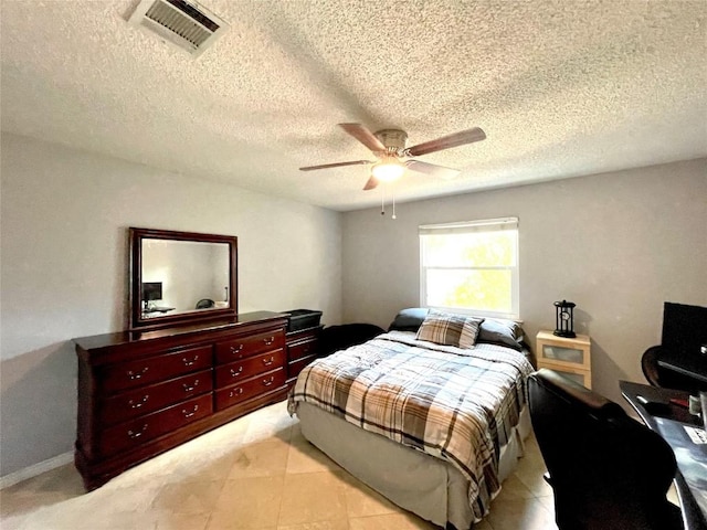 tiled bedroom with a textured ceiling and ceiling fan