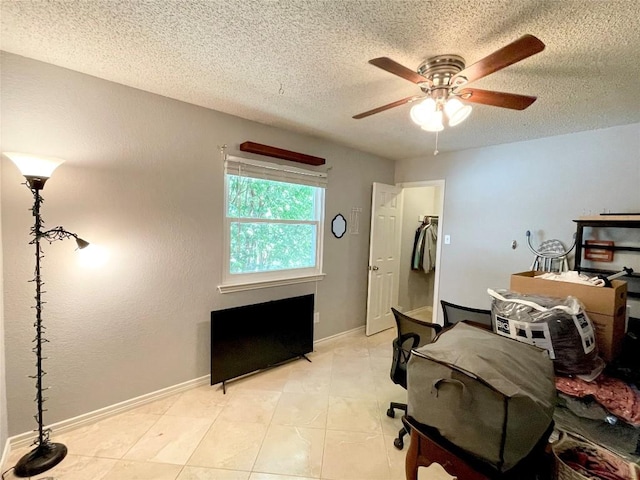 tiled bedroom with a textured ceiling and ceiling fan