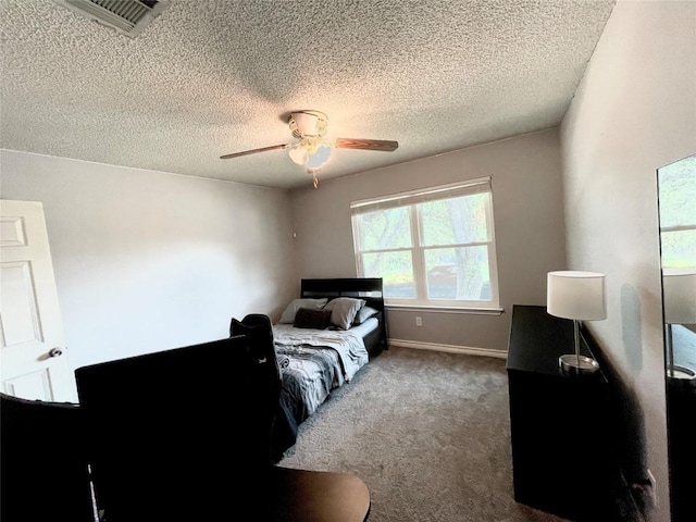 bedroom featuring a textured ceiling, carpet floors, and ceiling fan