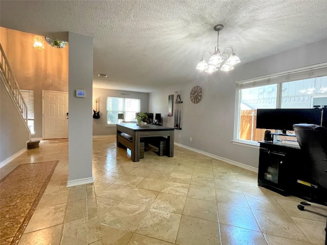 office area featuring a textured ceiling and a chandelier