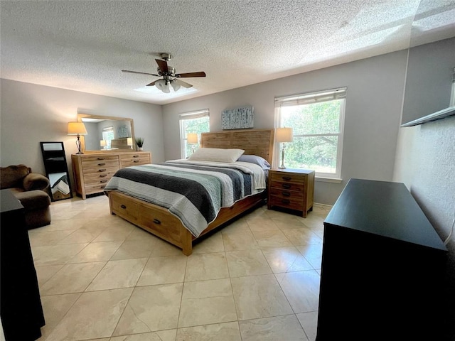 tiled bedroom featuring ceiling fan and a textured ceiling