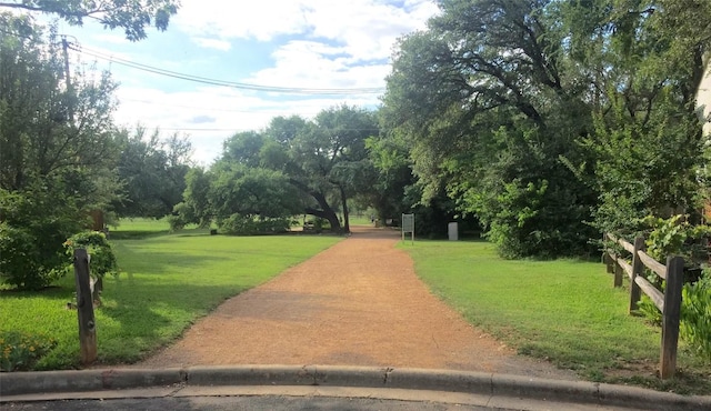 view of property's community featuring a yard