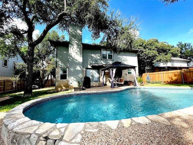 13242 Kerrville Folkway, Austin, TX 78729 - rear view of house featuring a chimney, a fenced backyard, a gazebo, and a patio area