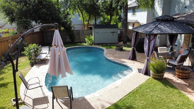 view of pool featuring a gazebo, a yard, a patio, and a storage shed