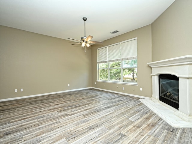 unfurnished living room with ceiling fan and light wood-type flooring