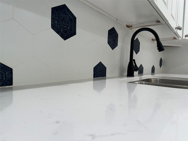 details with white cabinets and sink