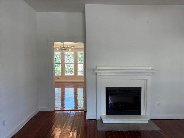 unfurnished living room with ceiling fan and dark hardwood / wood-style flooring