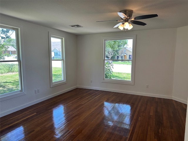 unfurnished room with dark wood-type flooring and ceiling fan