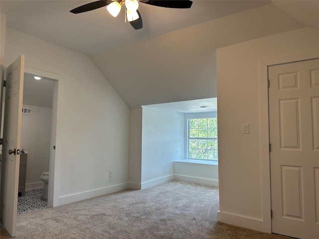 additional living space featuring vaulted ceiling, ceiling fan, and light colored carpet