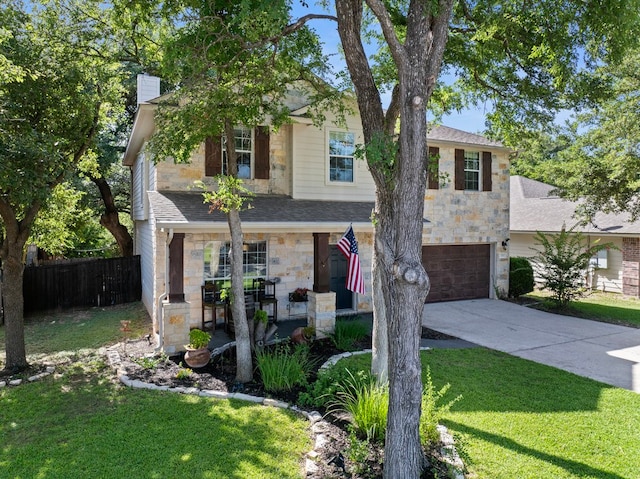 view of front of house with a front yard and a garage