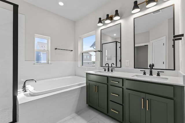 bathroom with shower with separate bathtub and vanity