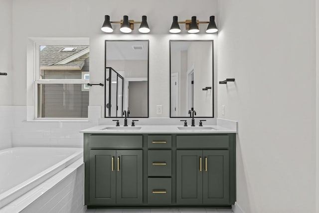 bathroom with vanity, tile patterned flooring, and a relaxing tiled tub