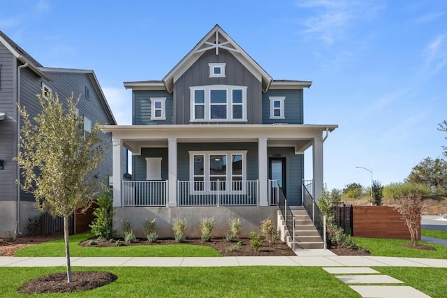 view of front of house with covered porch and a front lawn