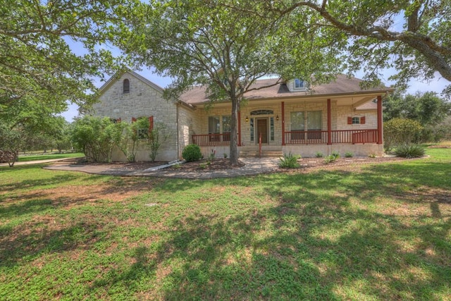 view of front of home with covered porch and a front yard