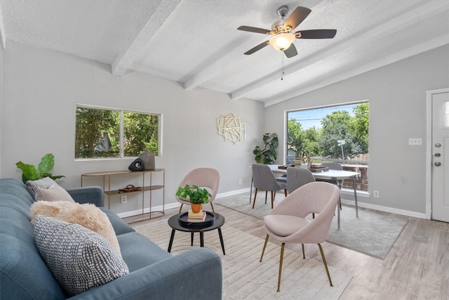 living room featuring lofted ceiling with beams, light hardwood / wood-style flooring, a textured ceiling, and ceiling fan