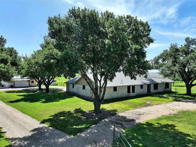 view of front of property featuring a garage and a front lawn