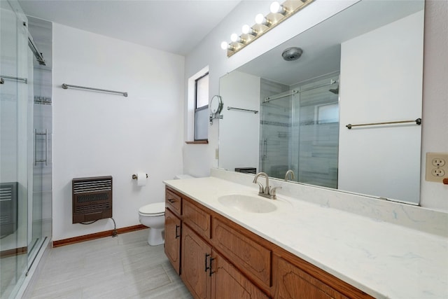 bathroom featuring vanity, heating unit, walk in shower, and toilet