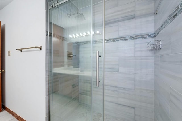 bathroom featuring a shower with shower door