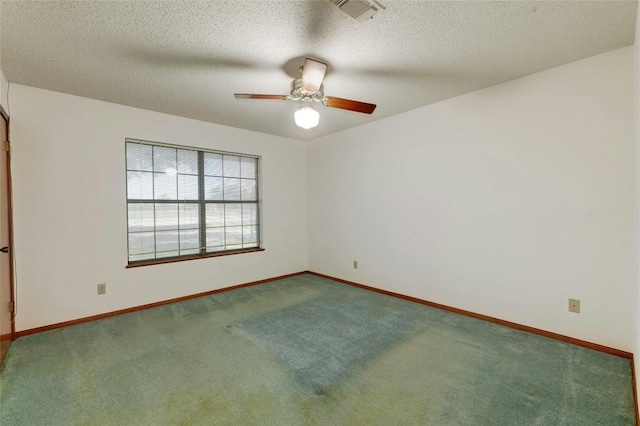 spare room featuring ceiling fan, carpet flooring, and a textured ceiling