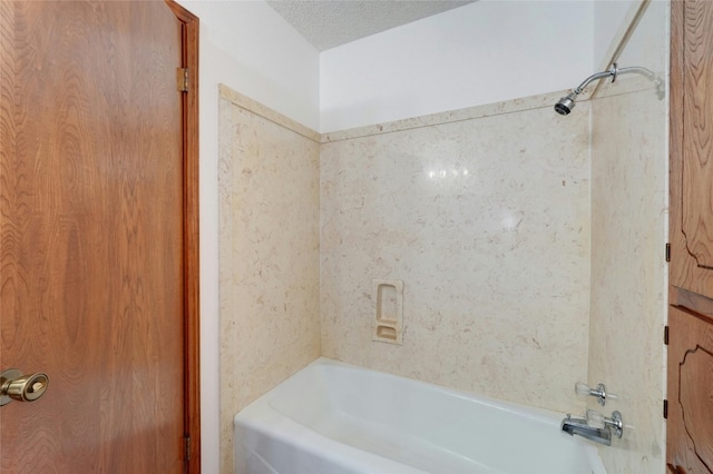 bathroom featuring shower / bath combination and a textured ceiling