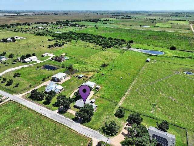 birds eye view of property with a rural view