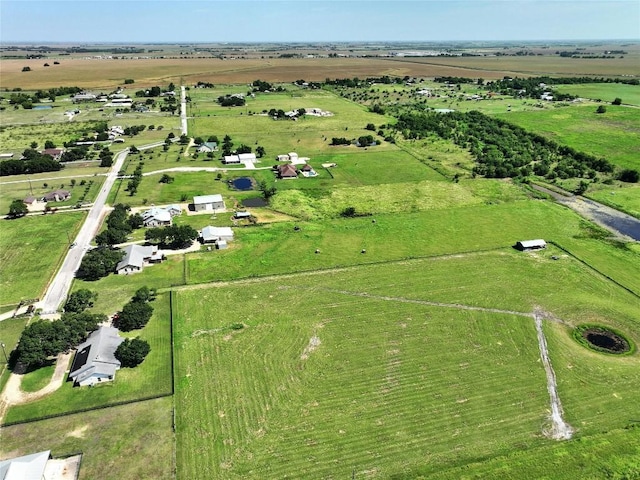 birds eye view of property with a rural view