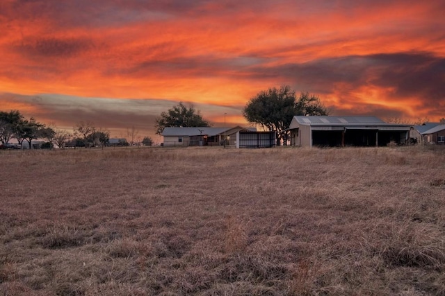 yard at dusk featuring an outbuilding