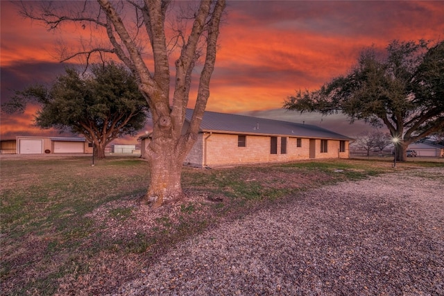 view of front of house with a garage and a lawn