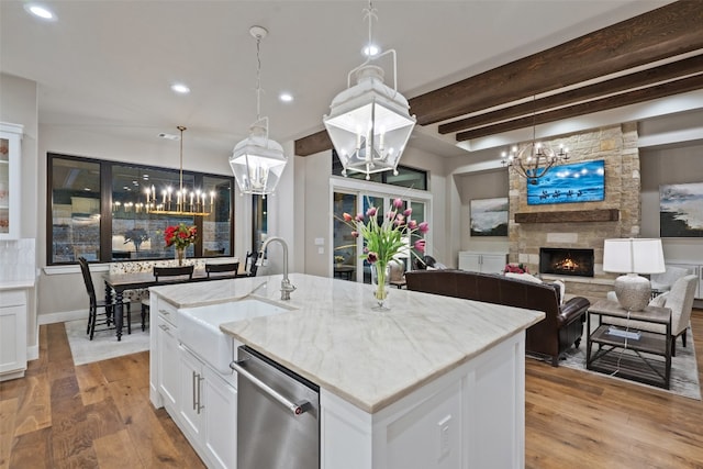 kitchen featuring dishwasher, light hardwood / wood-style flooring, and white cabinetry