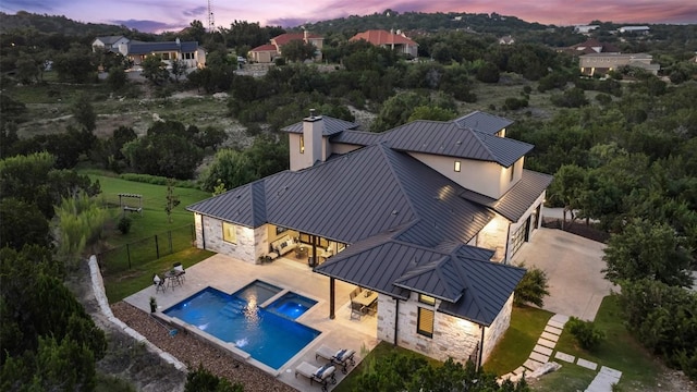 view of pool with a patio area, a fenced backyard, and a pool with connected hot tub