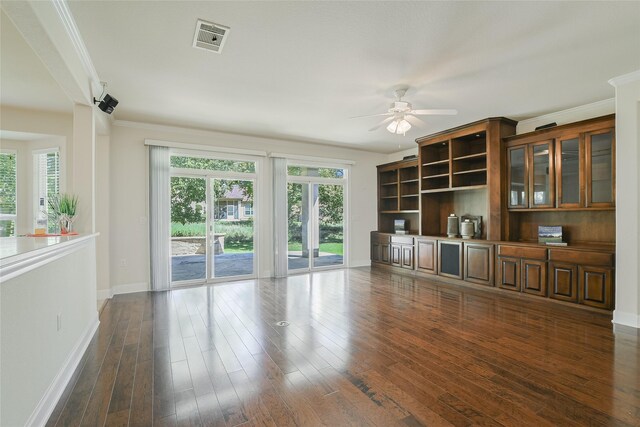 unfurnished living room featuring ornamental molding, ceiling fan, and dark hardwood / wood-style floors