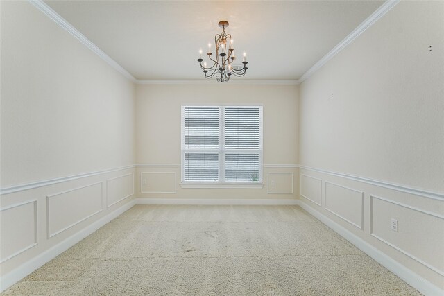 empty room featuring a chandelier, ornamental molding, and carpet flooring