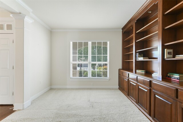 office space featuring light carpet, decorative columns, and crown molding