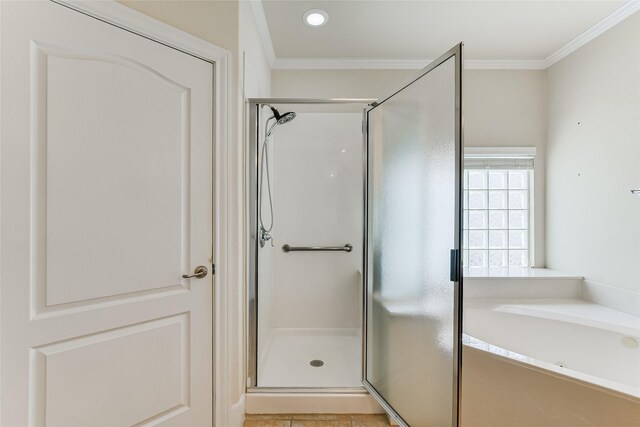 bathroom featuring plus walk in shower, tile patterned flooring, and ornamental molding