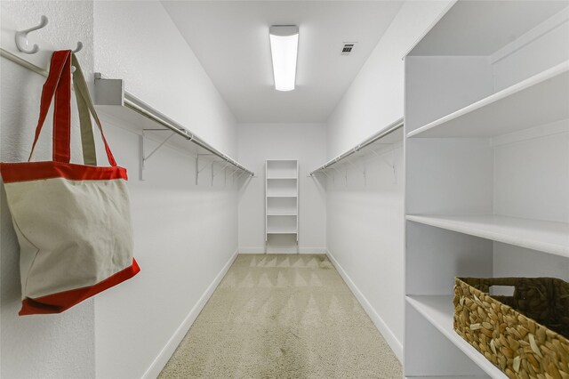 walk in closet featuring carpet