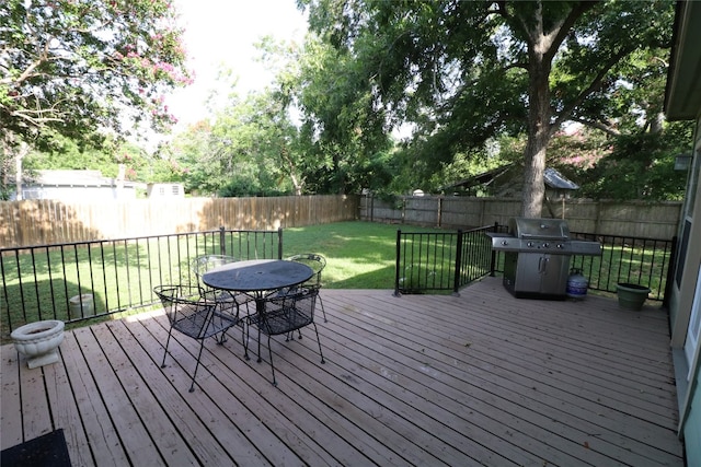 deck with area for grilling and a lawn