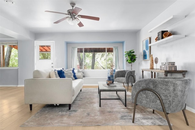 living room featuring ceiling fan and light hardwood / wood-style flooring