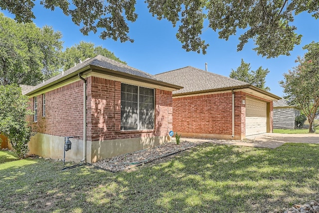 ranch-style home featuring a garage and a front yard