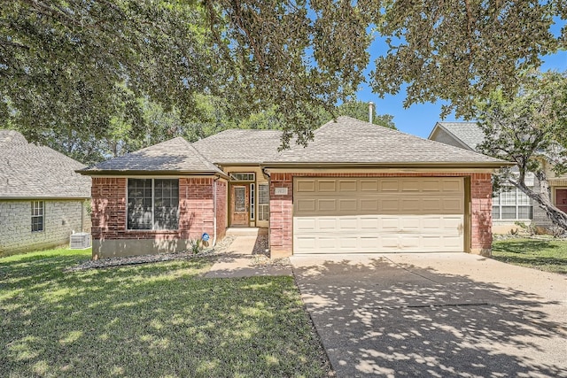 ranch-style house with central AC, a front yard, and a garage