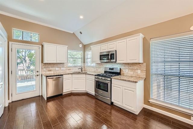 kitchen featuring lofted ceiling, sink, white cabinetry, and stainless steel appliances