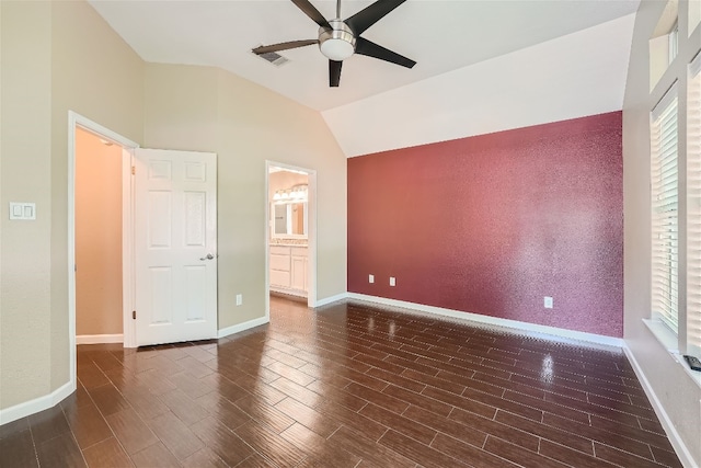 unfurnished bedroom featuring ensuite bath, ceiling fan, and lofted ceiling