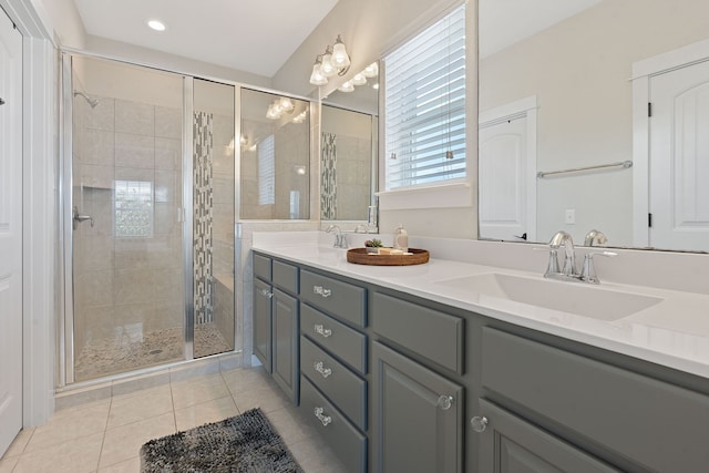 bathroom featuring walk in shower, vanity, and tile patterned flooring